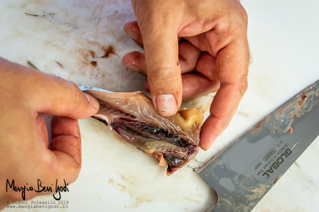 Apertura a libro del pesce sopra tagliere