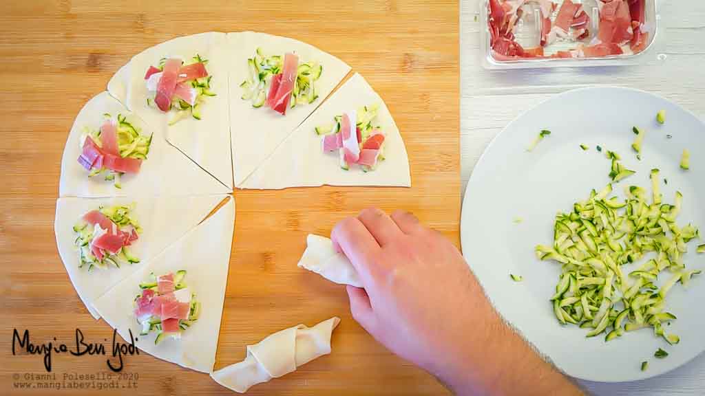 Arrotolare i cornetti di sfoglia con speck zucchine e philadelphia